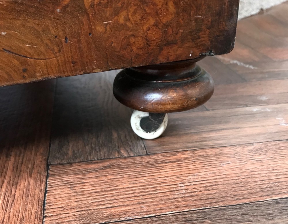 A late Victorian burr walnut Davenport desk featuring a sloped green leather writing surface, decorative brass gallery, inlaid side panel, and four side drawers. View VI