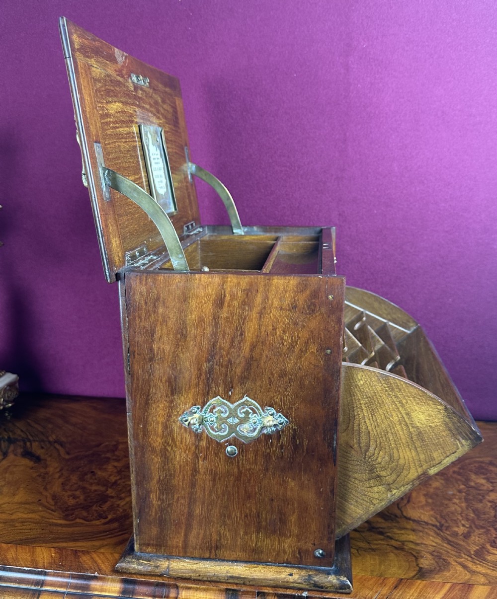 An Edwardian warm brown wooden stationery cabinet decorated with floral marquetry inlay and fitted with a brass keyhole escutcheon. View VI