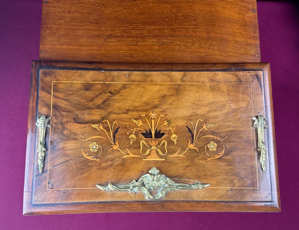 An Edwardian warm brown wooden stationery cabinet decorated with floral marquetry inlay and fitted with a brass keyhole escutcheon. View VIII