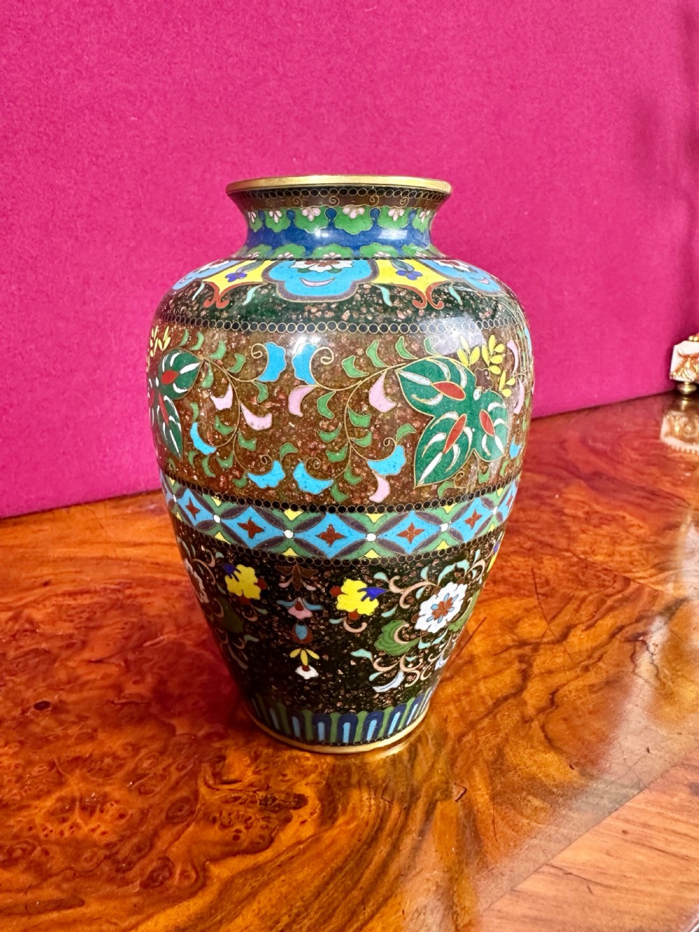 A Japanese Meiji period cloisonne enamel vase decorated with bird and floral motifs against a goldstone speckled ground. View II