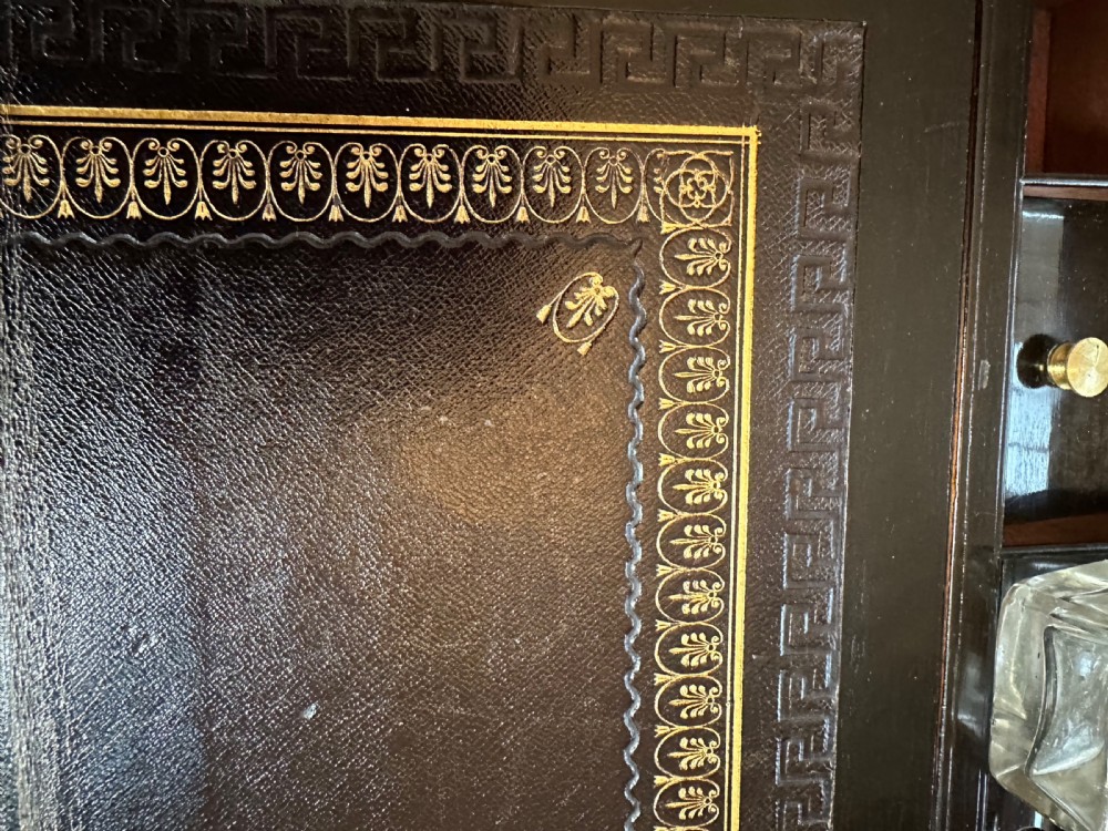 A dark rosewood campaign correspondence box featuring brass edge trim, a central rectangular brass nameplate, and a key inserted into the brass keyhole escutcheon. View IX
