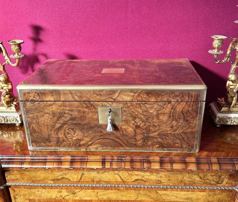 A rectangular Victorian document box made from figured burr walnut veneer with brass bound corners and a brass keyhole escutcheon. View III