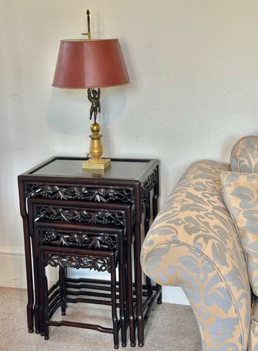 A set of four dark hardwood Chinese nesting tables featuring openwork carved bamboo aprons and faux-bamboo legs. View XII