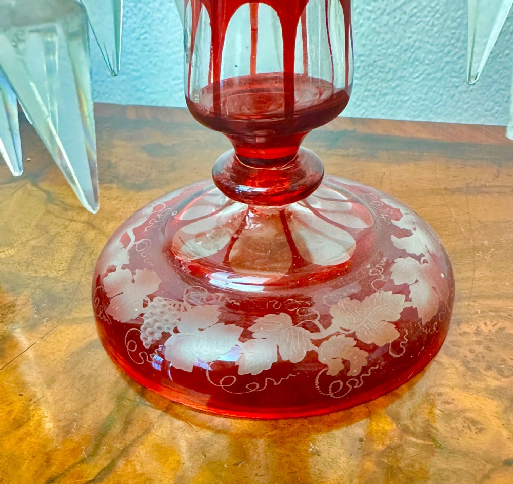 A pair of 19th-century Victorian ruby red flash glass lustres with acid-etched stag scenes, scalloped rims, and suspended clear crystal prism drops. View VIII