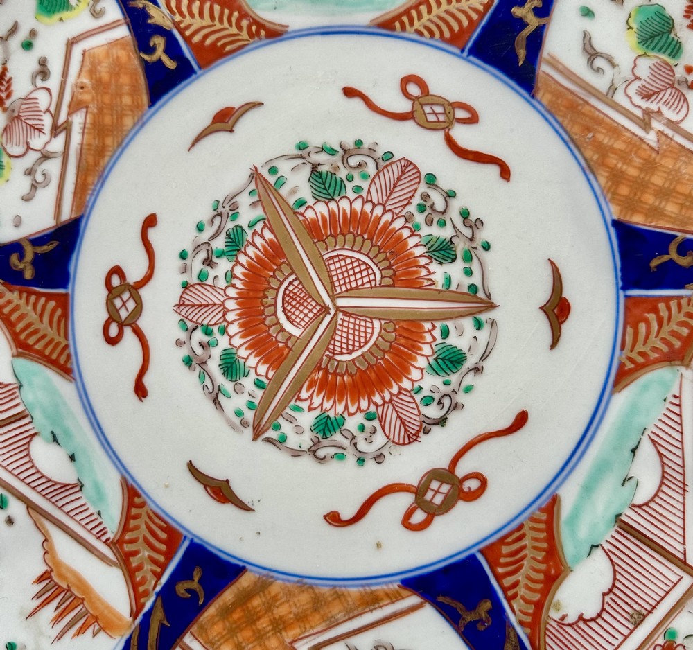 A circular Japanese Imari porcelain charger featuring cobalt blue and iron-red panelled decorations with floral motifs and phoenix figures. View VI