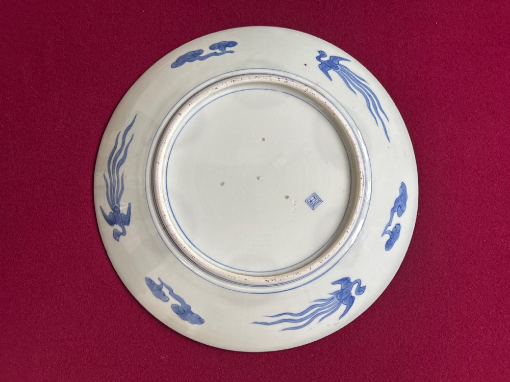 A circular Japanese Imari porcelain charger featuring cobalt blue and iron-red panelled decorations with floral motifs and phoenix figures. View VIII