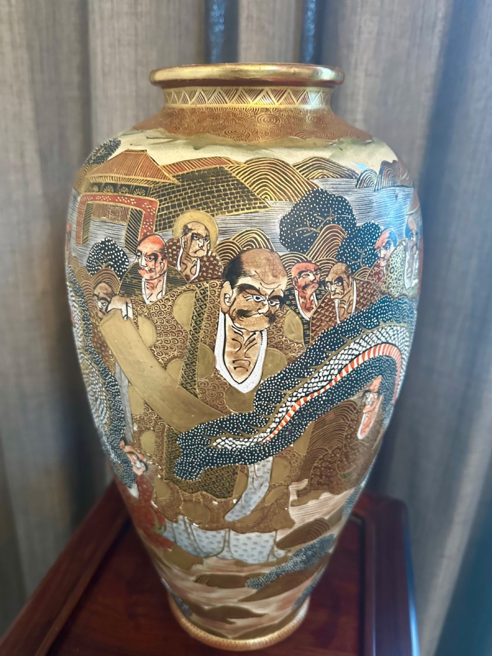 A large Japanese Satsuma earthenware vase featuring detailed hand-painted figures with halos, highlighted with heavy gold leaf accents. View II