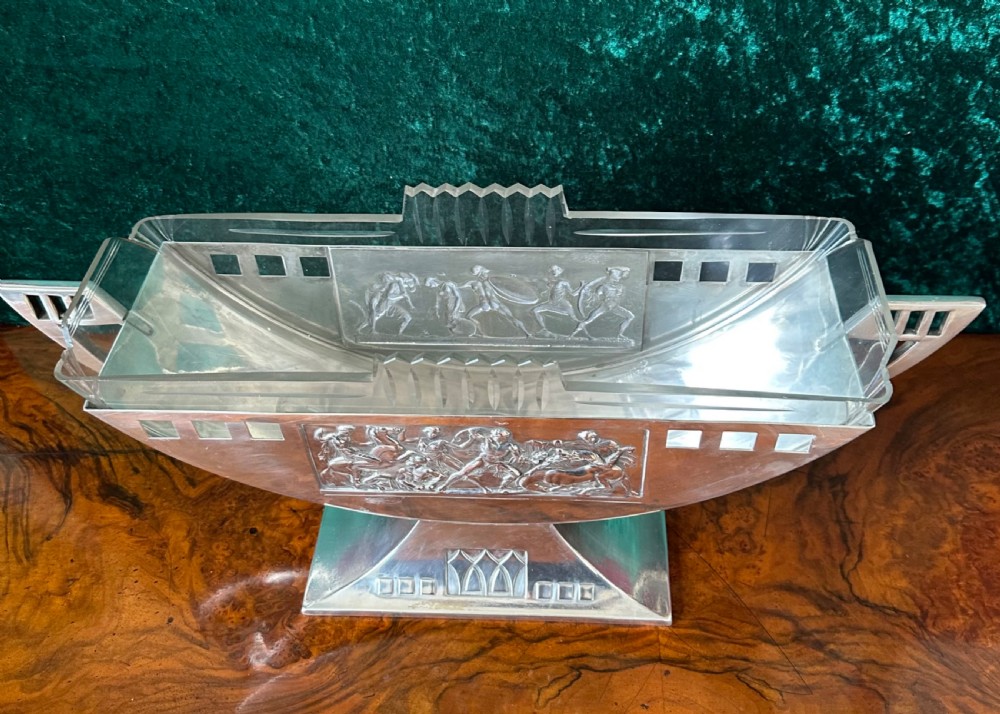 An Art Deco silver-plated boat-shaped tazza with a central classical relief panel and a fitted cut glass liner. View V