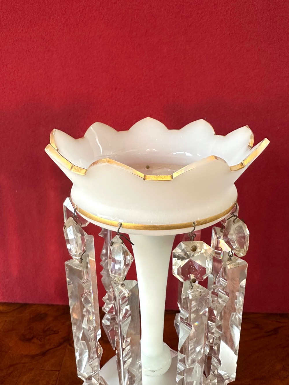 A pair of Victorian frosted white glass lustres featuring crenellated gilt-rimmed tops and suspended clear cut-crystal spearhead prisms. View II