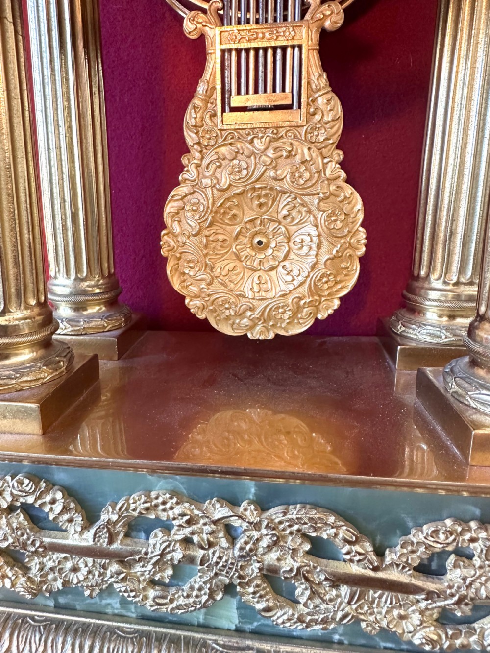 A 19th-century French clock garniture featuring a central portico-style green onyx mantel clock with gilt-bronze mounts flanked by two matching five-light candelabra. View II