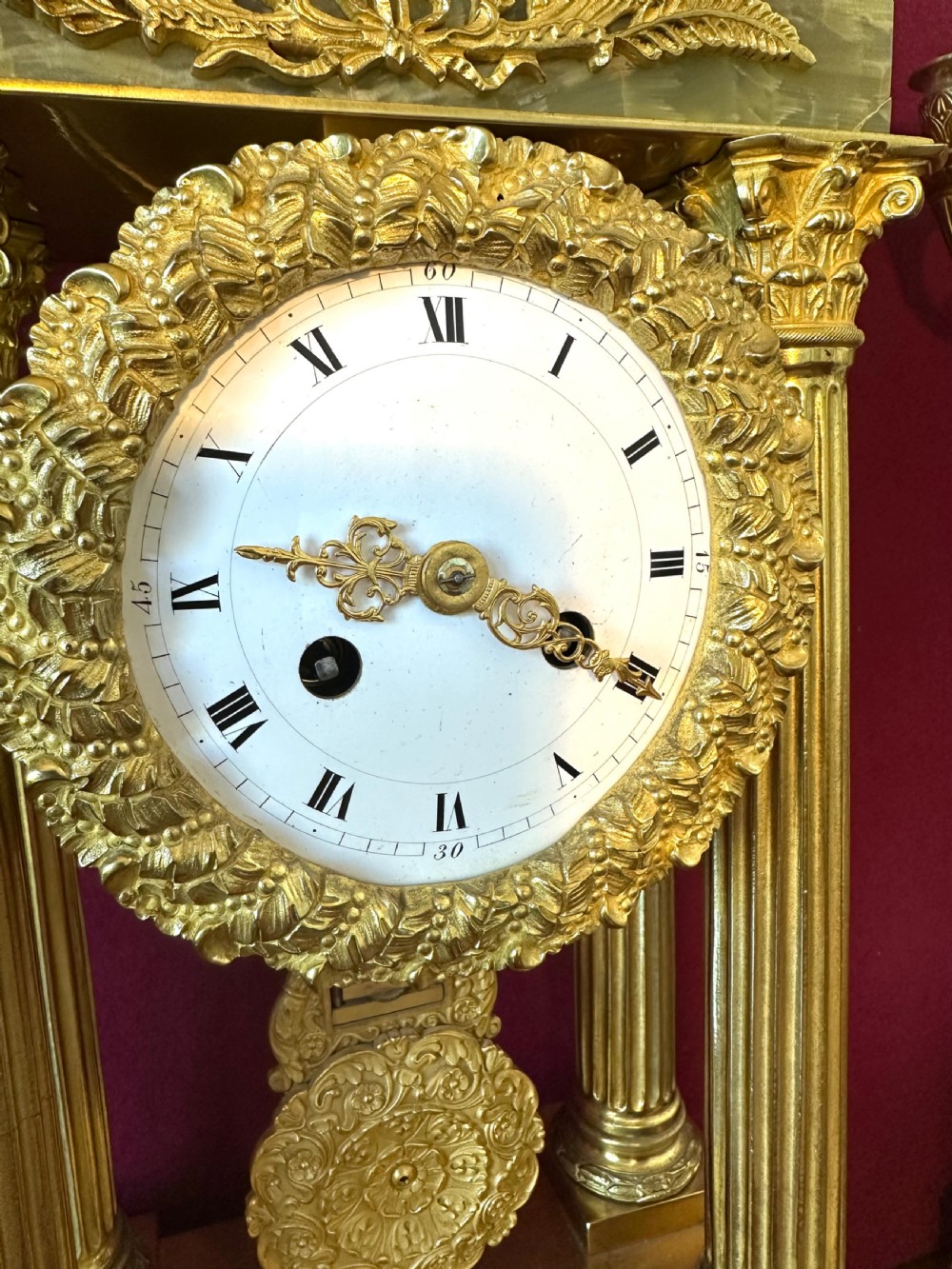 A 19th-century French clock garniture featuring a central portico-style green onyx mantel clock with gilt-bronze mounts flanked by two matching five-light candelabra. View III