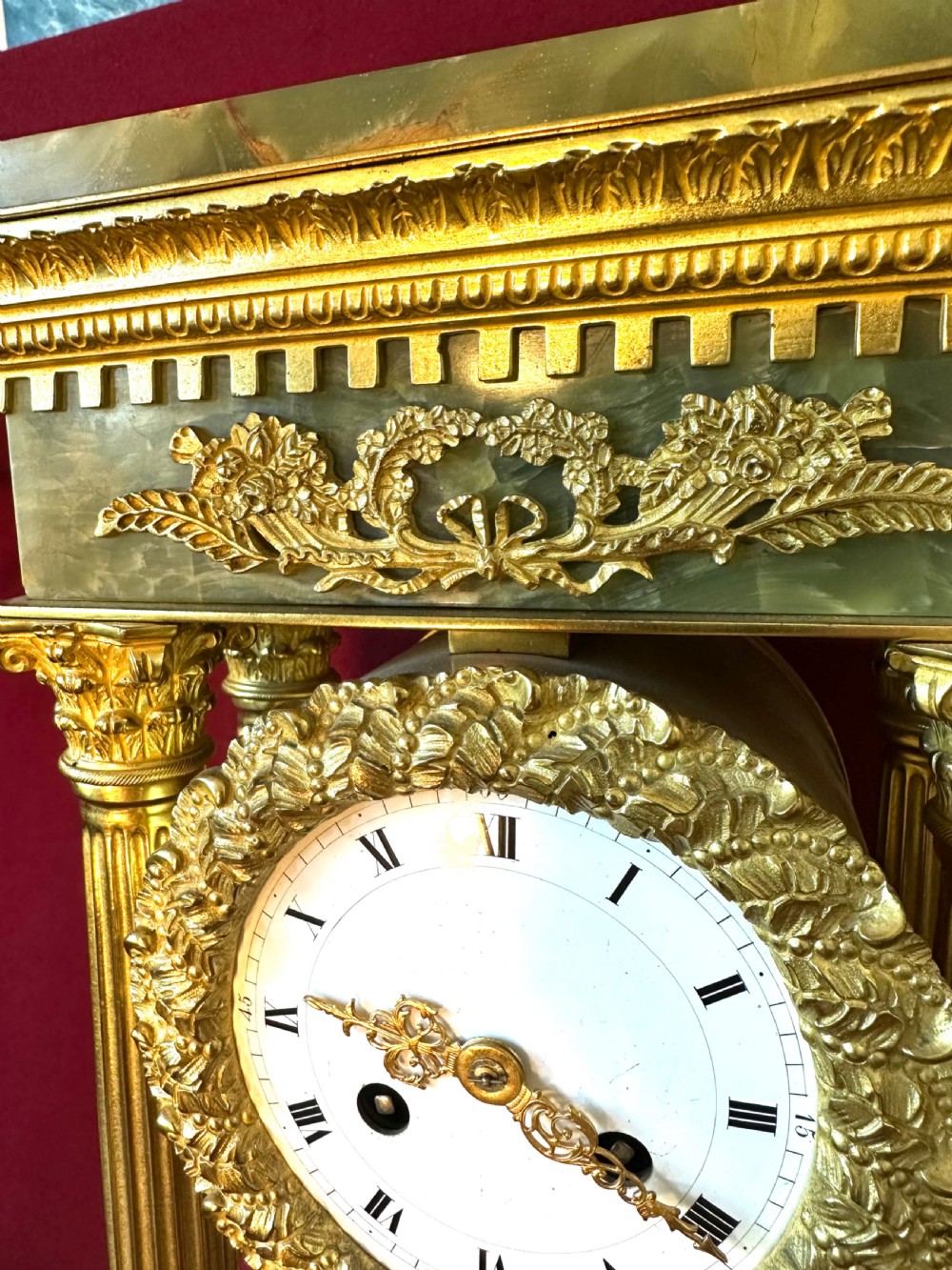 A 19th-century French clock garniture featuring a central portico-style green onyx mantel clock with gilt-bronze mounts flanked by two matching five-light candelabra. View VI