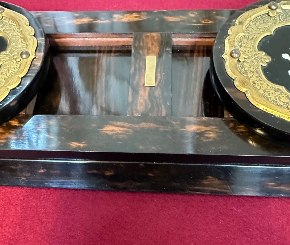 An expanding Victorian desk book slide crafted from dark coromandel wood, featuring hinged arch-shaped ends set with pietra dura floral stone inlays surrounded by engraved brass mounts. View IV