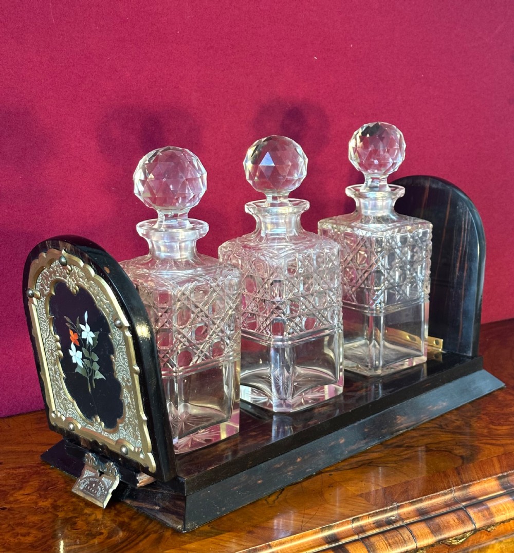 An expanding Victorian desk book slide crafted from dark coromandel wood, featuring hinged arch-shaped ends set with pietra dura floral stone inlays surrounded by engraved brass mounts. View V