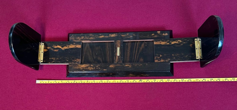 An expanding Victorian desk book slide crafted from dark coromandel wood, featuring hinged arch-shaped ends set with pietra dura floral stone inlays surrounded by engraved brass mounts. View VII