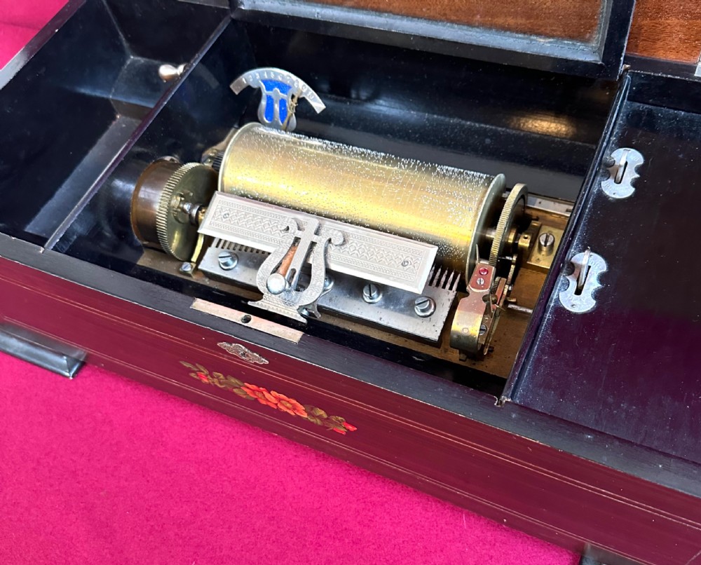 A rectangular Victorian dark rosewood music box featuring floral marquetry inlay on the lid and ebonised corner feet. View III