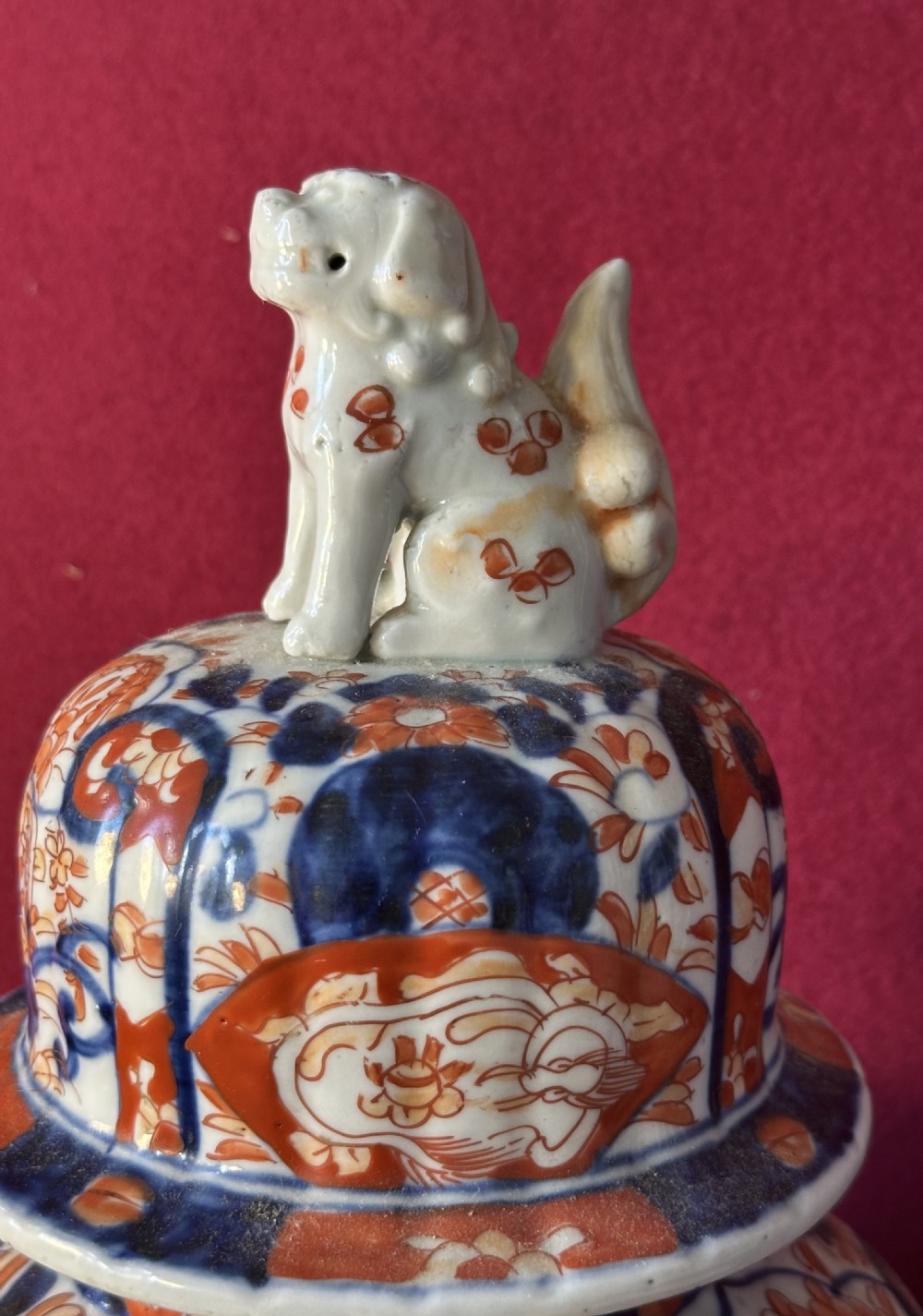 Japanese Imari porcelain covered vase featuring cobalt blue and iron red floral patterns with a shishi lion finial on the lid. View III
