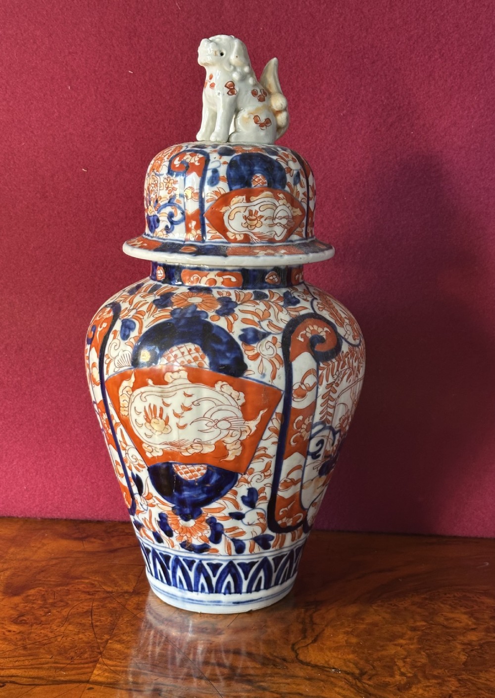 Japanese Imari porcelain covered vase featuring cobalt blue and iron red floral patterns with a shishi lion finial on the lid. View V