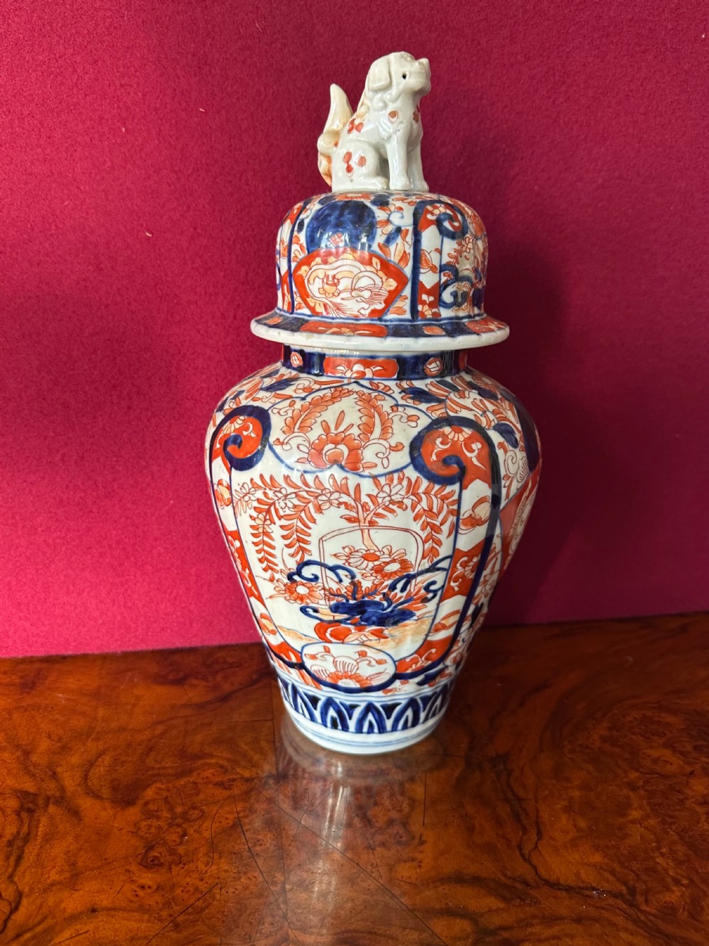 Japanese Imari porcelain covered vase featuring cobalt blue and iron red floral patterns with a shishi lion finial on the lid. View VI