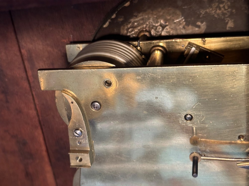 A Georgian mahogany bracket clock featuring brass inlay, lion mask handles, a top brass finial, and a circular dial signed Thos Marsh Dorking. View VII