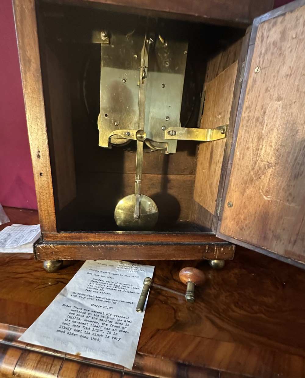A Georgian mahogany bracket clock featuring brass inlay, lion mask handles, a top brass finial, and a circular dial signed Thos Marsh Dorking. View VIII