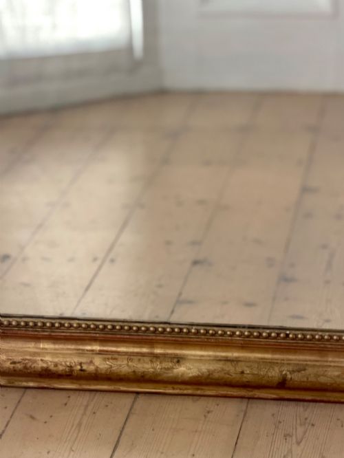 fig 1. Large rectangular French Louis Philippe mirror featuring rounded upper corners, a beaded inner border, and a gilded finish.