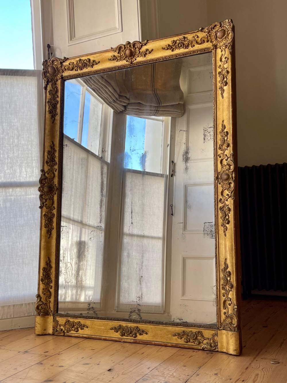 Large antique French gilt leaner mirror 