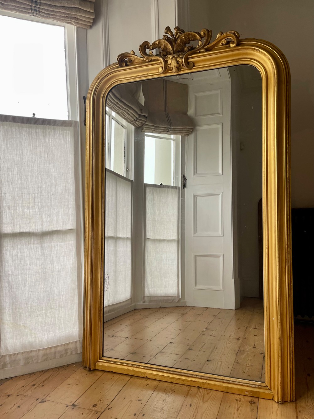 Large antique French gilt leaner mirror