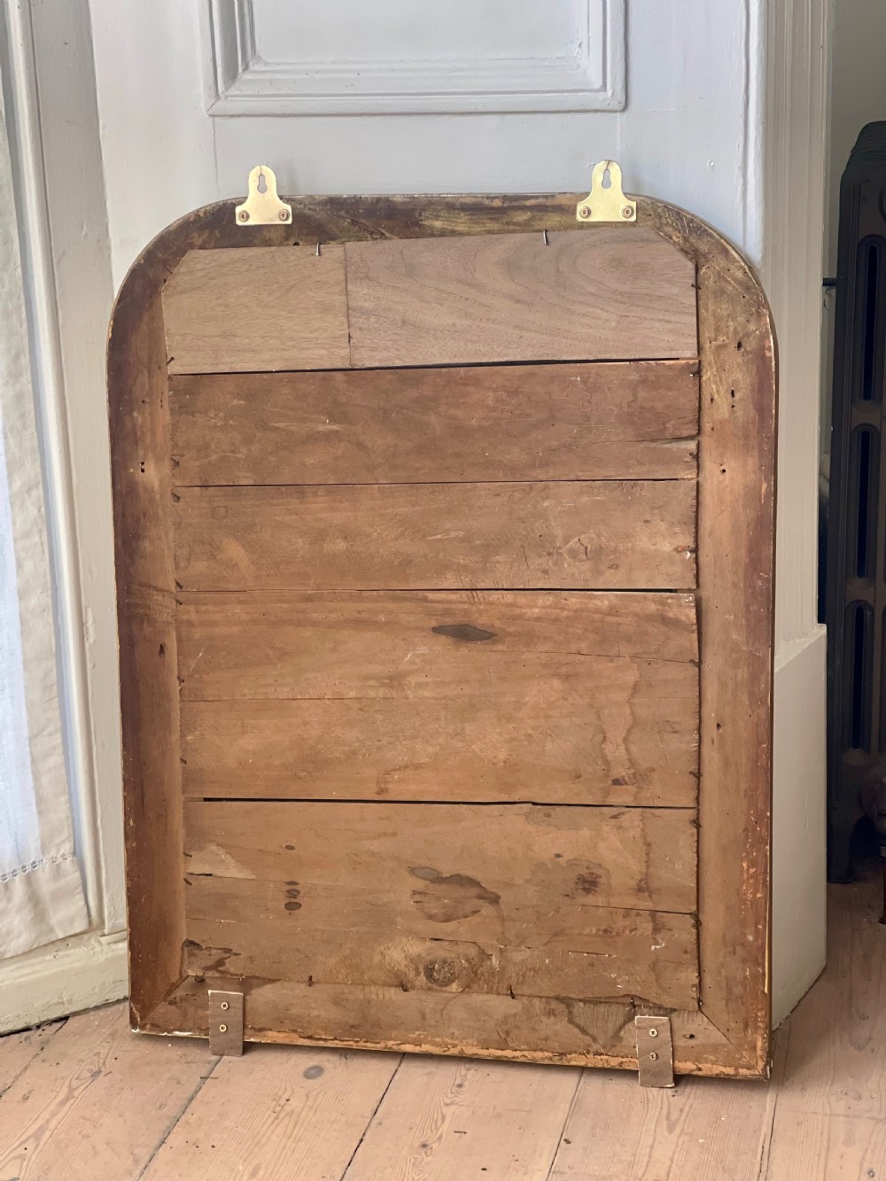 An upright antique French Louis Philippe mirror featuring an ogee-moulded frame with a gilded gold leaf finish and rounded upper corners. View II