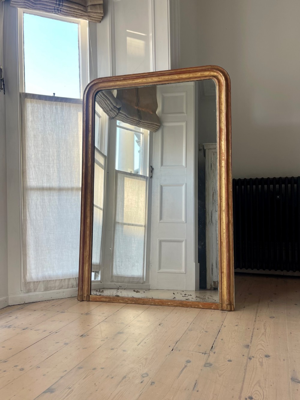 Large antique French worn gilt mirror