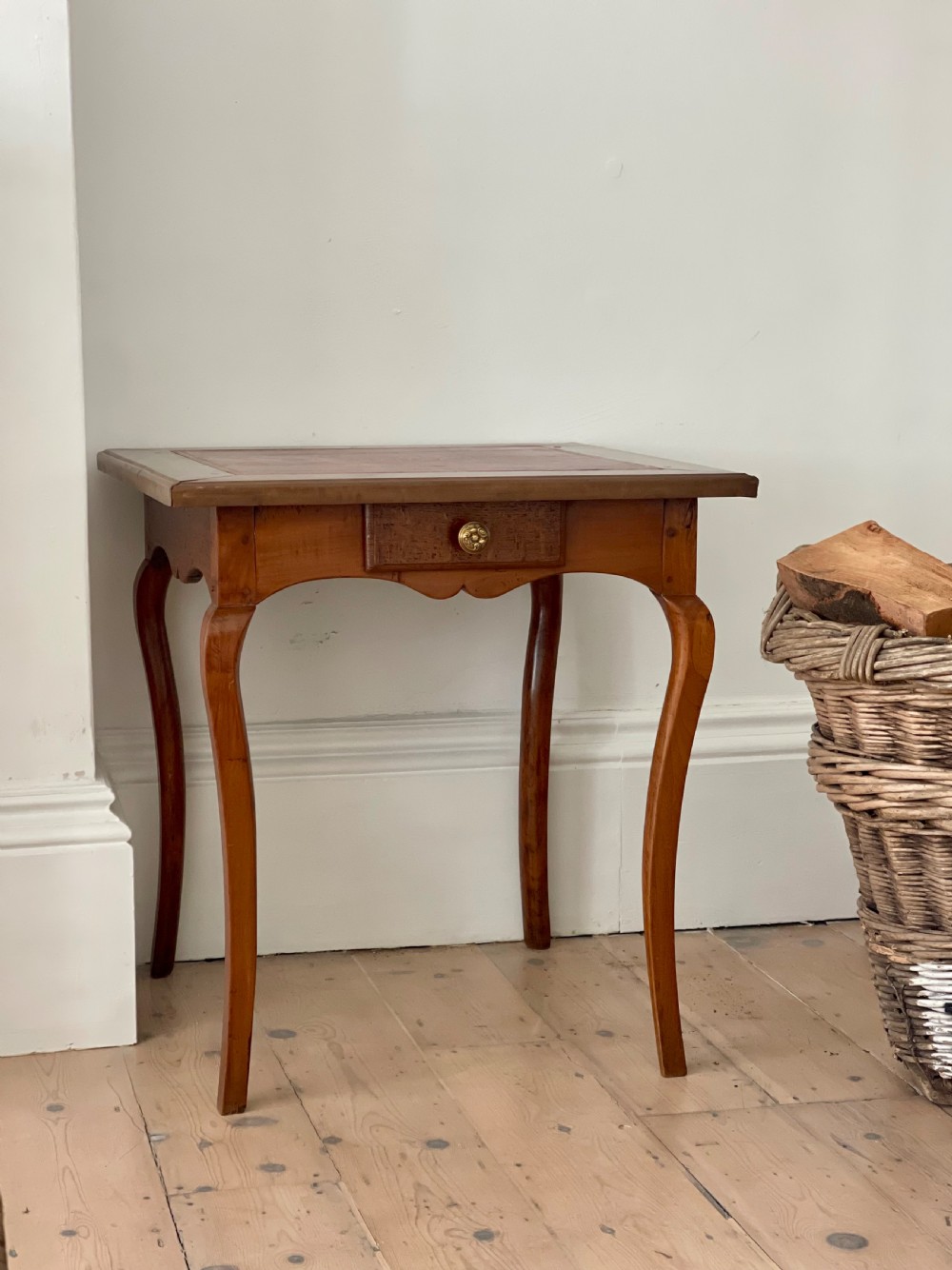 An antique French side table featuring a warm brown leather inset top, slender cabriole legs, and a single drawer with a brass knob. View III