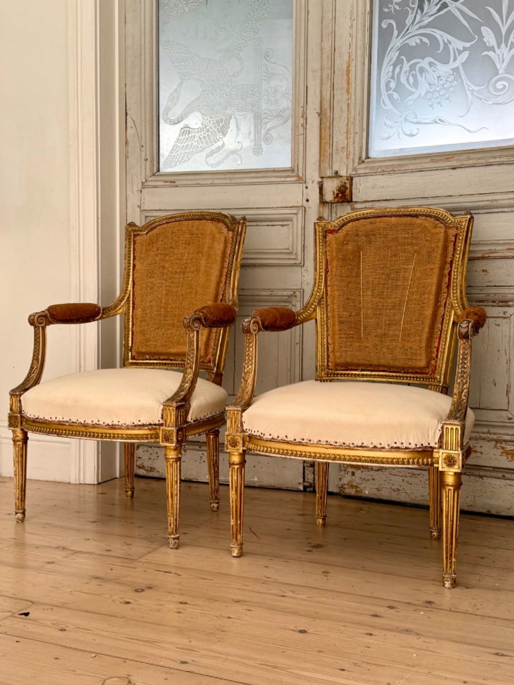 Pair of antique French giltwood armchairs