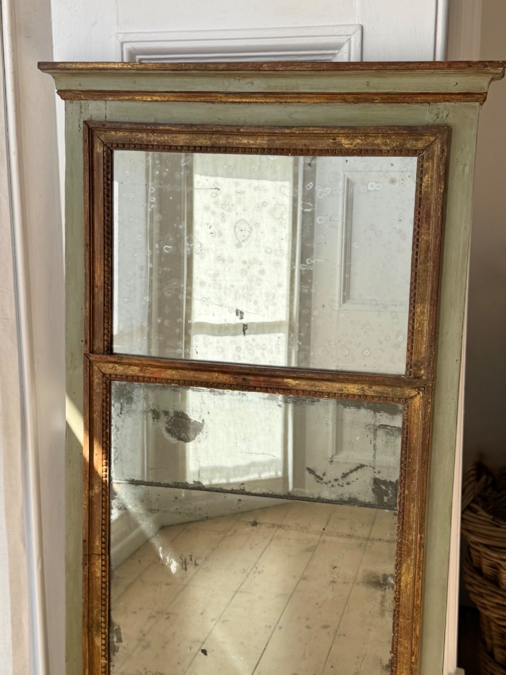 A tall rectangular French trumeau mirror featuring a sage green painted outer timber frame, a beaded gilt inner border, and two distressed mercury glass plates. View III