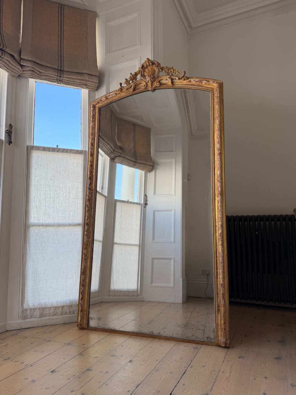 Large antique French gilt leaner mirror