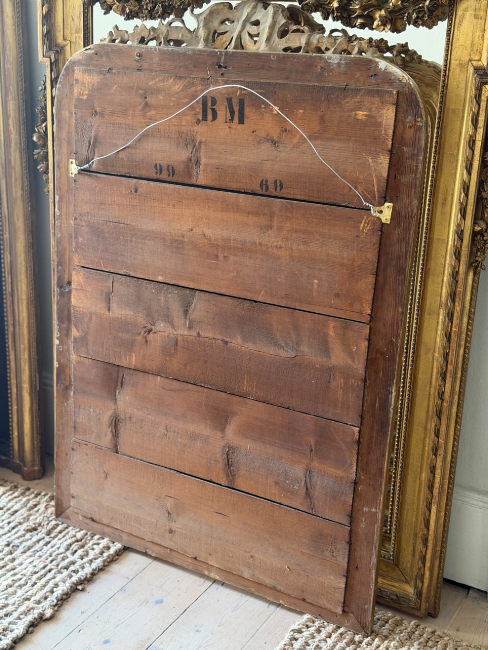 An antique French Louis Philippe giltwood mirror featuring a carved crest and incised floral frame detailing. View XIII