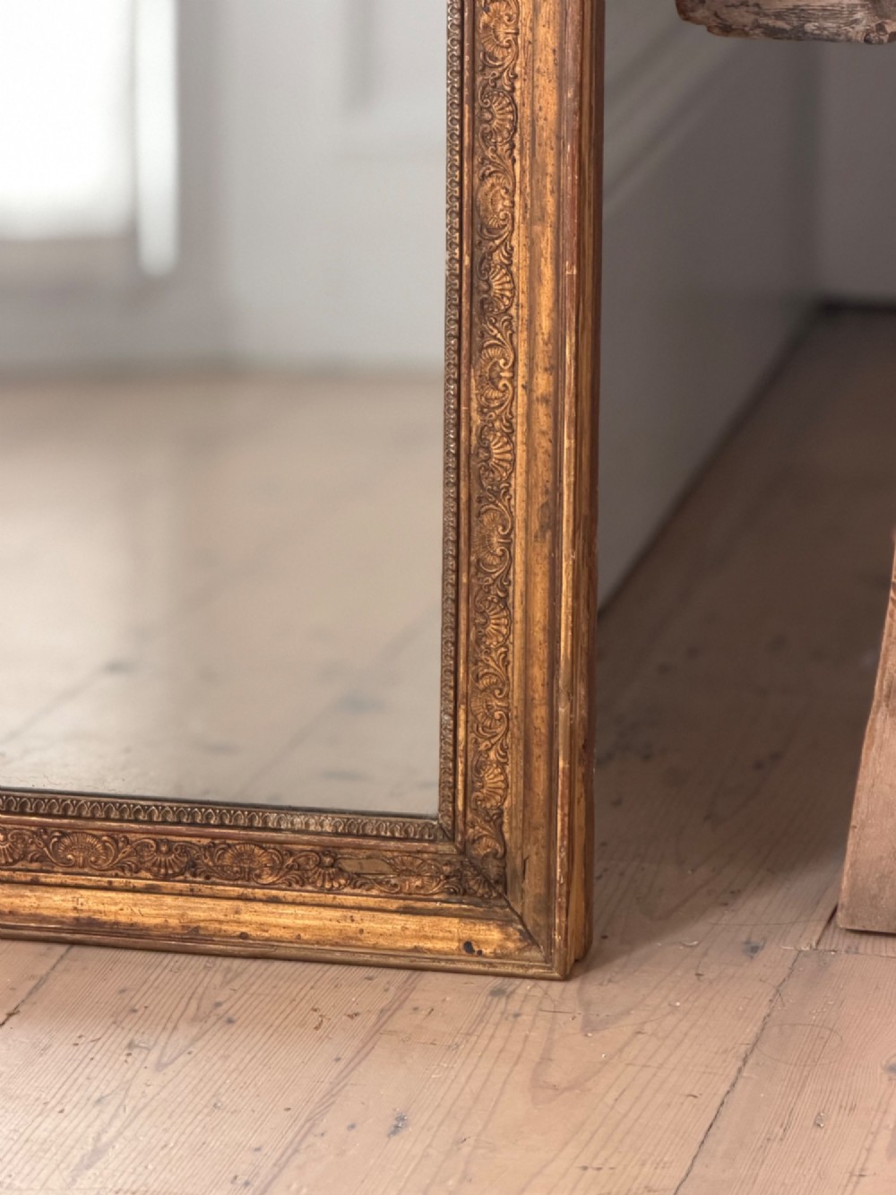 A tall 18th-century French rectangular mirror featuring a carved gold leaf frame and a two-part split mercury glass plate. View VI