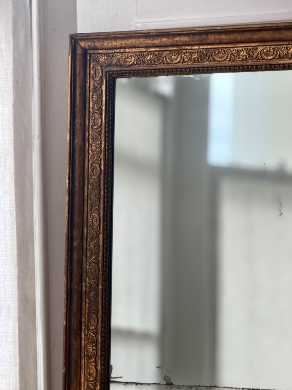 A tall 18th-century French rectangular mirror featuring a carved gold leaf frame and a two-part split mercury glass plate. View VII