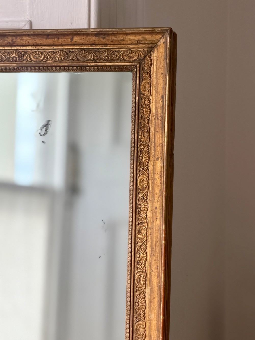 A tall 18th-century French rectangular mirror featuring a carved gold leaf frame and a two-part split mercury glass plate. View VIII