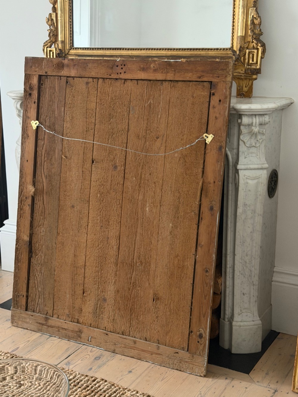 A rectangular 18th-century French giltwood mirror featuring heavy foxing on the glass plate and carved corner rosette details. View VIII
