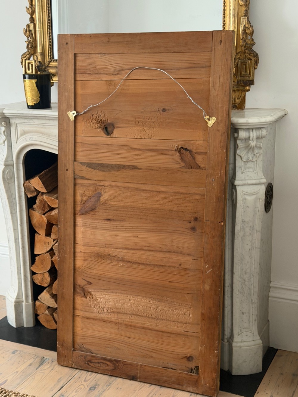 A tall 18th-century French rectangular mirror featuring a carved gold leaf frame and a two-part split mercury glass plate. View XII