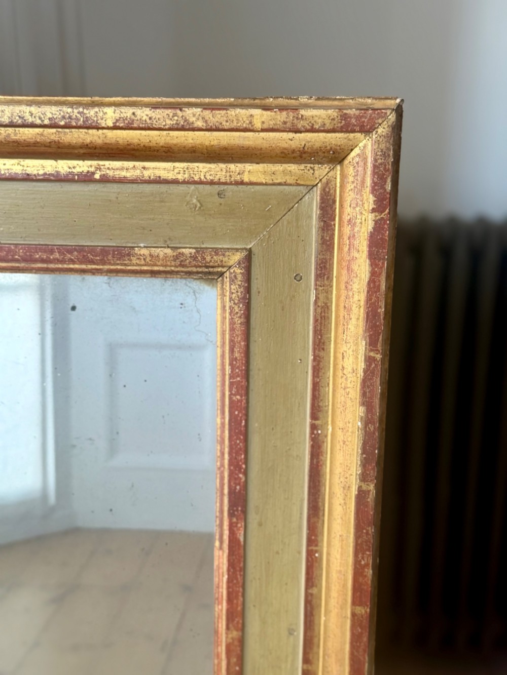 A large rectangular antique French mirror with a gold leaf and sage green painted wooden frame housing an original mercury glass plate. View II