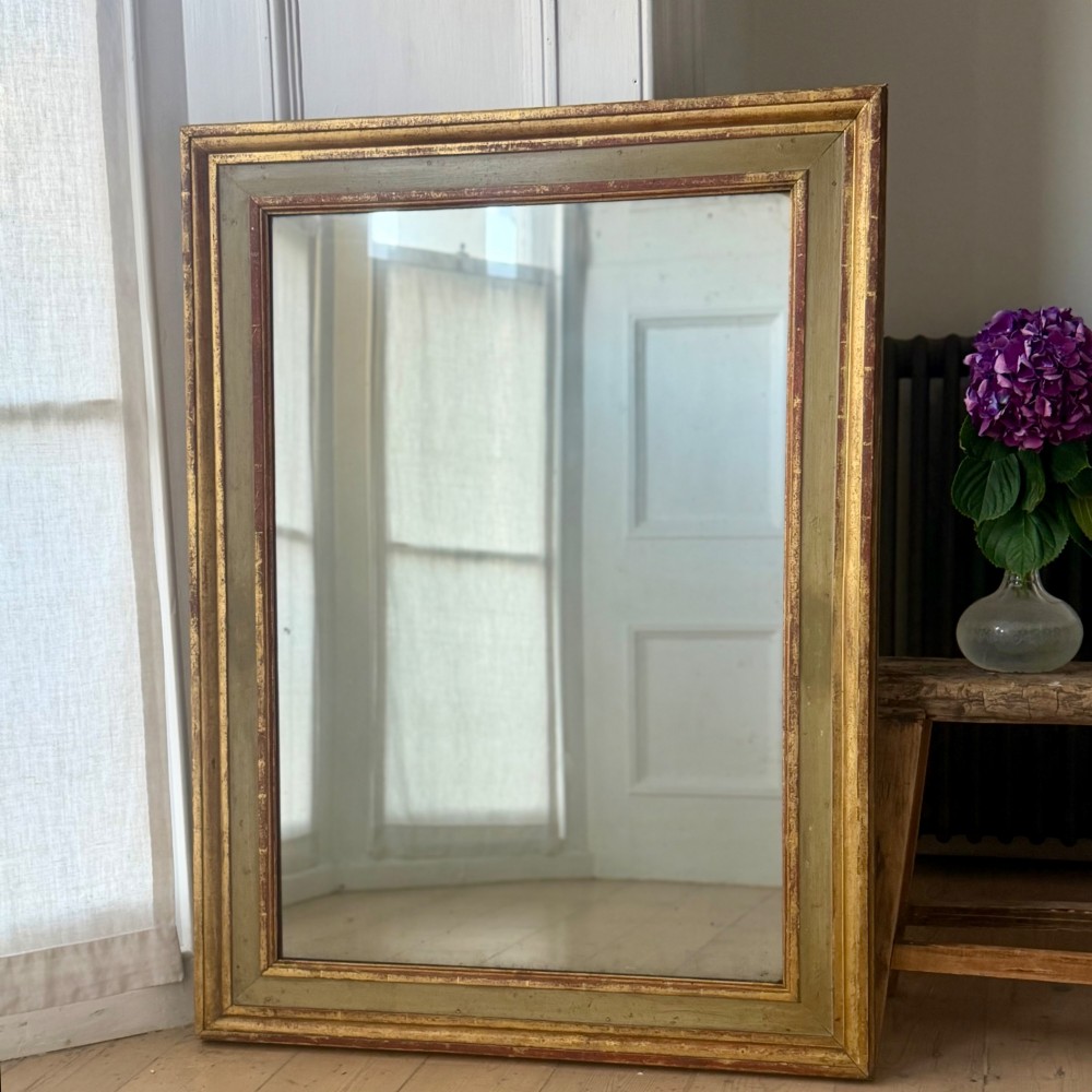 A large rectangular antique French mirror with a gold leaf and sage green painted wooden frame housing an original mercury glass plate. View III