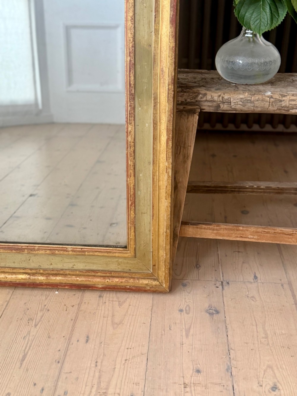 A large rectangular antique French mirror with a gold leaf and sage green painted wooden frame housing an original mercury glass plate. View IV