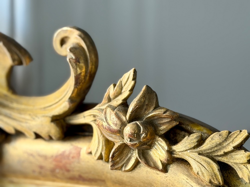 A tall rectangular French Louis Philippe wall mirror with rounded top corners, an elaborate carved shell cresting, a gold gilt frame over red gesso, and a beaded inner trim. View IX