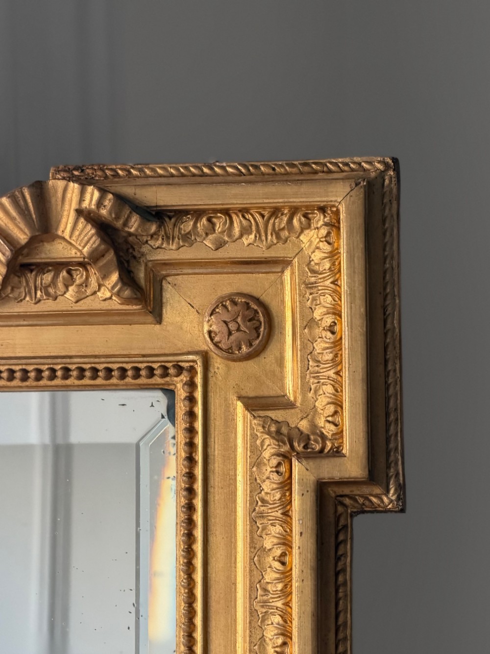 A tall rectangular gold giltwood full-length mirror featuring a carved bow ribbon cresting, beaded inner frame, and bevelled glass plate. View III