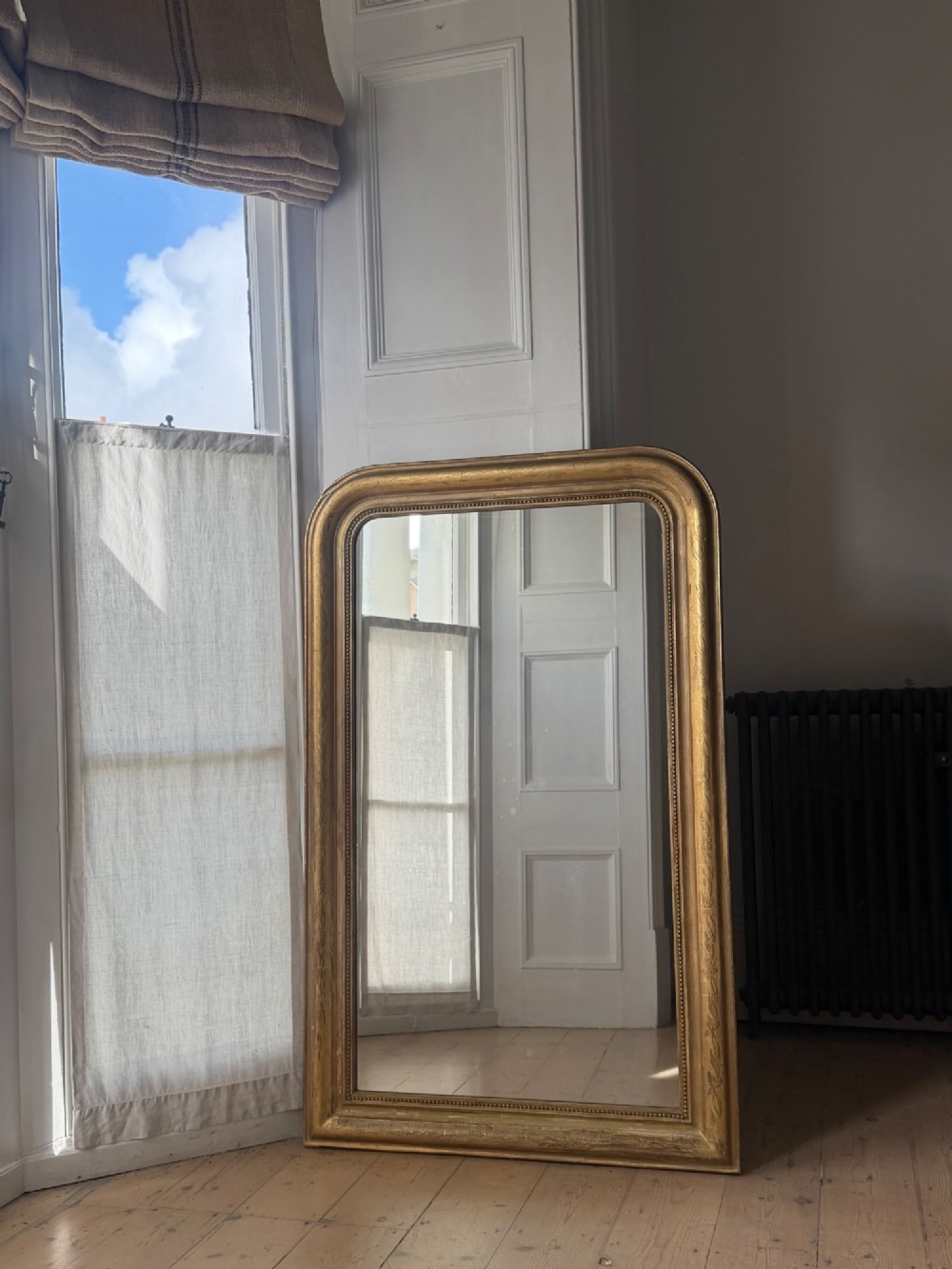 A mid-19th-century French Louis Philippe mirror featuring a gilded frame with rounded upper corners and subtle beaded detailing. View III