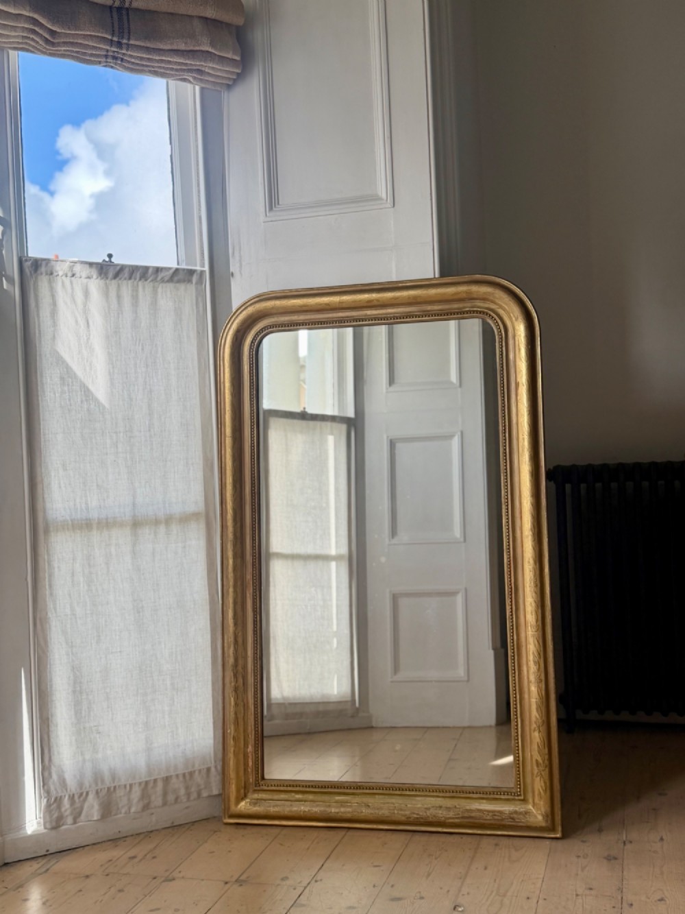 A mid-19th-century French Louis Philippe mirror featuring a gilded frame with rounded upper corners and subtle beaded detailing. View IV