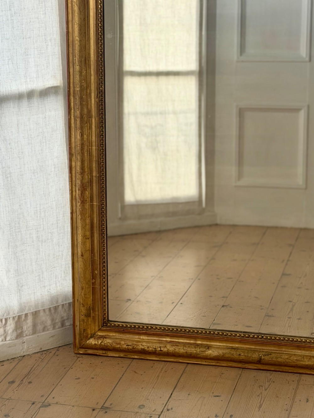 Large rectangular French Louis Philippe mirror featuring rounded upper corners, a beaded inner border, and a gilded finish. View V