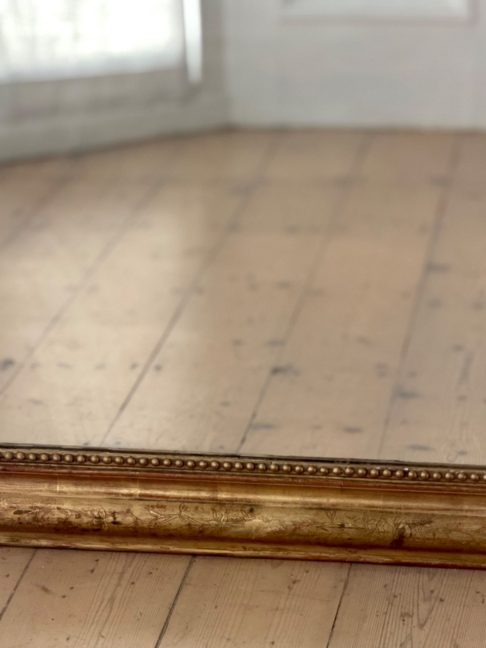 Large rectangular French Louis Philippe mirror featuring rounded upper corners, a beaded inner border, and a gilded finish. View VIII