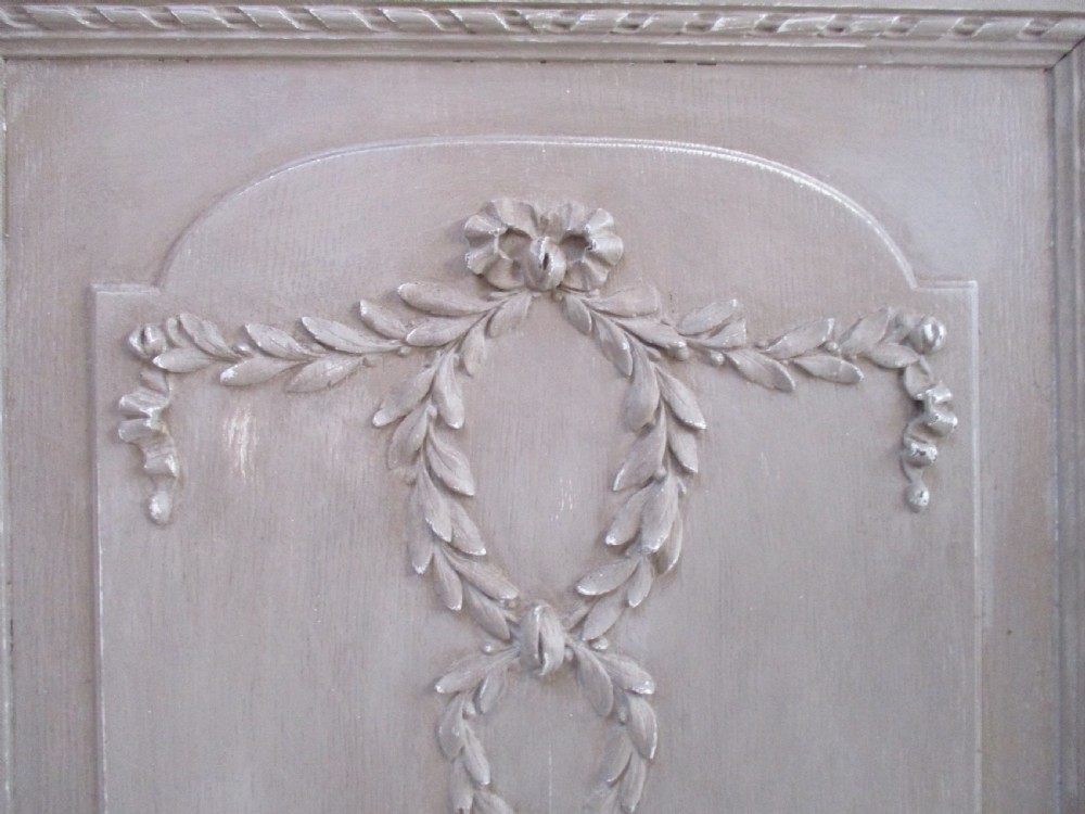 A pair of grey painted wooden cabinet doors decorated with hand-carved laurel wreaths and ribbon swags. View II